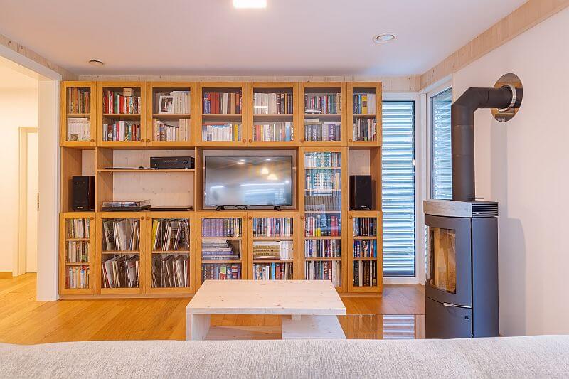 moderni-drevostavba-prodesi-domesi-interier-obyvaci-pokoj-drevena-podlaha-krbova-kamna-knihovna-foto-milan-hutera